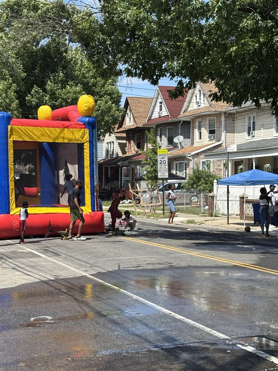 A bouncy house set up in the middle of Albany Avenue with the street closed to traffic